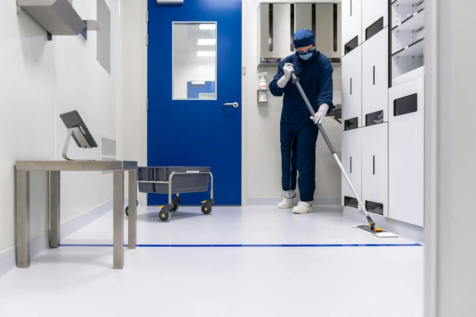 Trained cleaner disinfecting a clinical room